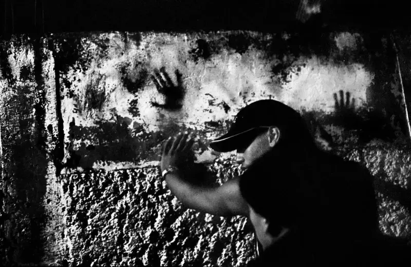 A young man is searched for weapons during a police raid in the slum of Catia. Catia, Caracas, Venezuela. 2004 © Christopher Anderson, Альбом: Christopher Anderson, Capitolio